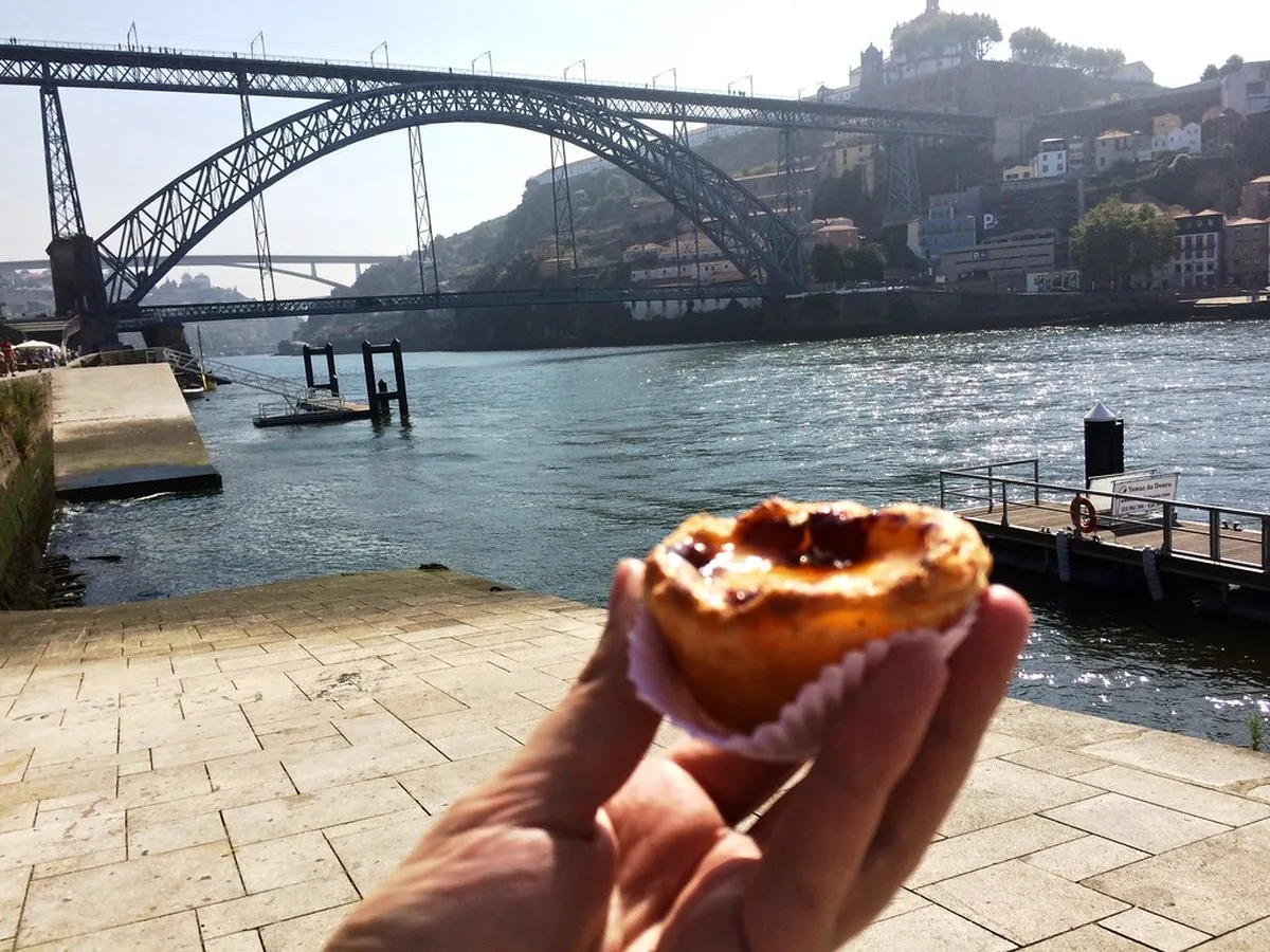 Golden Pastel de Nata custard tarts fresh from a Porto bakery, with their signature caramelised tops dusted in cinnamon