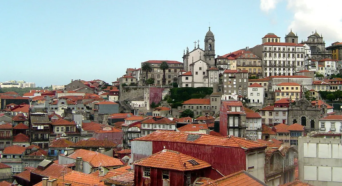 Sweeping panoramic view over Porto's terracotta rooftops and the Douro River from above the historic city